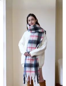Close-up of thick plaid cashmere scarf with long tassels in grey and pink colors