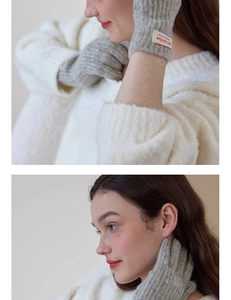 Detailed texture of grey plush knit gloves with tactile wrist brand label and soft yarn