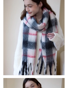 Macro detail of soft plaid scarf with long fringe and thick knitted texture