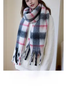 Close-up of thick plaid scarf featuring soft brushed texture and classic tassels
