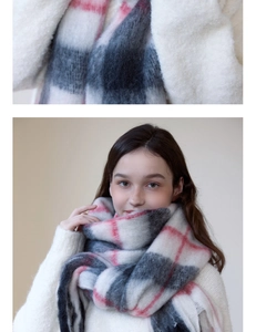 Detailed close-up of thick checkered cashmere-like scarf with soft fringe and red accents