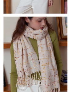 Detail of soft checkered scarf with fringe tassels and colorful grid pattern for winter