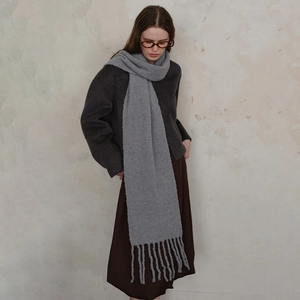Soft wool knit scarf in light grey with thick fringe tassels for winter warmth