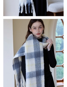 Close-up of thick plaid cashmere scarf with long tassels and soft checkered pattern