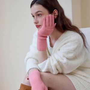 Pink wool blend knitted thermal gloves for women shown in a cozy winter fashion setting