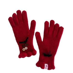 Elegant red wool blend knit gloves for women featuring black bows and frill cuffs