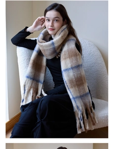 Close-up of thick plaid cashmere feel scarf with long tassels in earth tone and blue