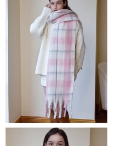 Detail of pink and white checkered scarf with soft fringe tassels and thick cashmere texture