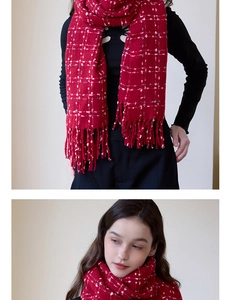 Detail of red plaid scarf showing soft cashmere-like texture and fringed tassels for winter