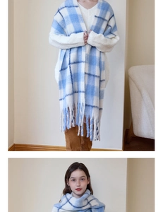 Close-up of thick blue and white checkered scarf with soft fringe tassels for winter