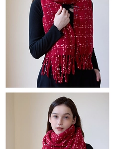 Detail view of a red knit scarf with fringe and snowflake pattern for winter warmth