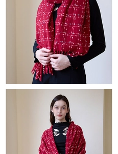 Close-up of red plaid scarf with fringe and soft knit texture for winter fashion