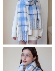 Close-up detail of blue and white plaid cashmere scarf with soft tassels for winter