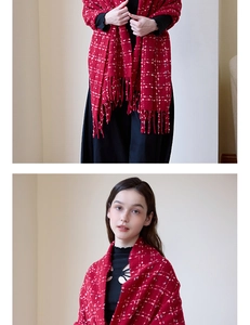 Detail of red tweed knit shawl with intricate blue plaid texture and long fringe tassels