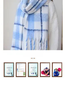 Close-up detail of blue and white plaid scarf with soft cashmere-like texture and tassels