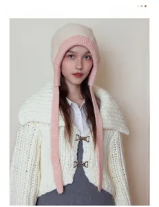Detailed texture of thick knit cardigan featuring unique metal clasp and cozy plush fabric