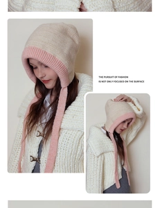 Detail of soft knit texture and long straps on a winter two-tone contrast warm hood hat