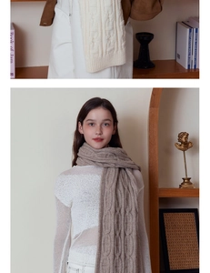Detail of chunky cable knit scarves in beige and light brown showing soft winter texture