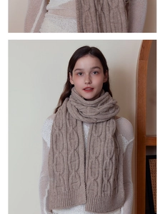 Detailed close-up of thick cable knit texture on an oatmeal warm winter scarf