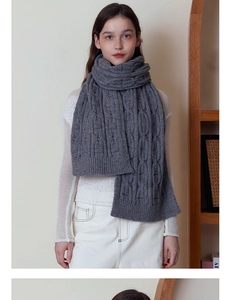 Close-up of dark grey thick cable knit scarf texture and premium soft warm wool yarn