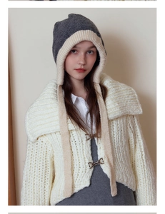 Detail of Hepburn style contrast knit ear protection hat with thick wool texture