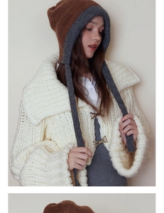 Detailed texture of grey and brown knitted earflap hat with long decorative straps