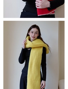 Detail of a thick fuzzy scarf with contrast stitched edges in bright yellow and red