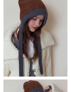 Detail of color-block knit ear protection hat in coffee and grey on model