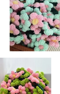 Detail of handmade crochet flowers with pink petals and green leaves in a woven basket