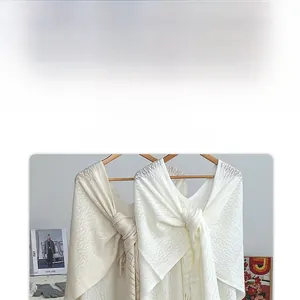 Detailed knit texture of vintage hollow-out shawls in jade white and wheat beige colors