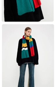 Close-up of vibrant striped mohair knit scarf featuring bold multi-color textured patterns