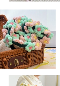 Close-up of handmade crochet rose and lily of the valley flowers in a wicker basket