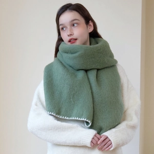 Chic grass green knitted scarf with white blanket stitch edges for winter warmth