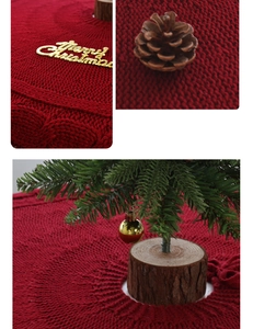 Detail of red cable knit Christmas tree skirt featuring a golden Merry Christmas lettering