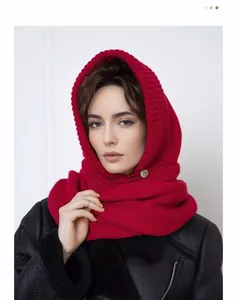 Close-up of a deep red knitted hooded scarf with a stylish decorative button detail