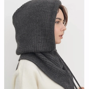 Detail view of dark grey knitted balaclava scarf showing warm thick texture and cord
