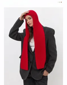 Close-up of red chunky knit balaclava hood scarf on a model with grey suit contrast