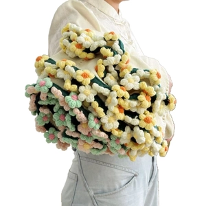 Handmade crochet tote bag with colorful 3D floral patterns and green woven handles