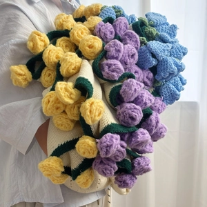 Detailed close-up of handmade crochet rose bouquet blanket with vibrant floral patterns