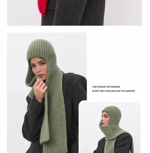 Detail of chunky knit hooded scarf in grass green with thick texture for winter warmth