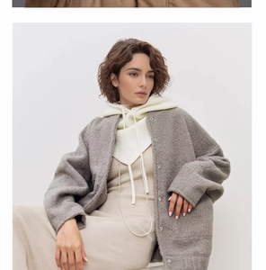 Detail of white knitted hood scarf paired with a grey cardigan and beige dress outfit
