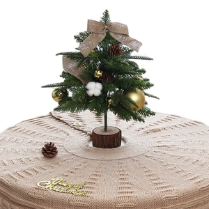 Knitted beige Christmas tree skirt with cable knit patterns and button closure