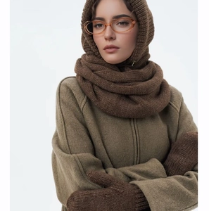 Close-up of deep brown knitted balaclava and matching gloves set for winter warmth