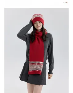 Detail of red Fair Isle knit scarf and hat set with classic geometric patterns