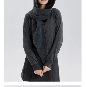 Detailed knit texture of a dark grey hooded scarf with premium soft minimalist finish