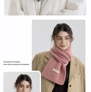 Detail of pink ribbed knit scarf with soft texture and white minimalist label tag