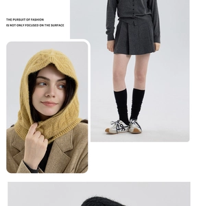 Close-up of ginger yellow cable-knit balaclava wool hood with high-end texture