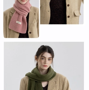 Detail view of pink and olive green ribbed knit scarves with soft cashmere-like texture