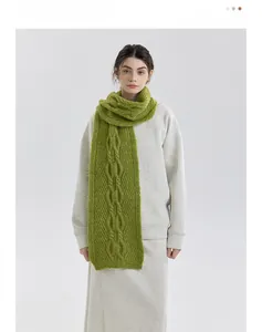 Detail of grass green cable-knit scarf showing thick texture and chunky braided pattern