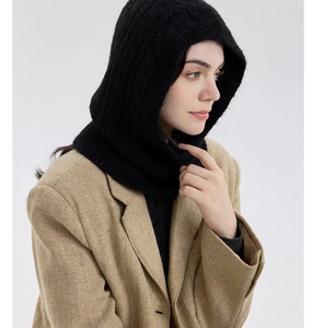 Detail of black cable knit balaclava showing thick wool texture and neck coverage
